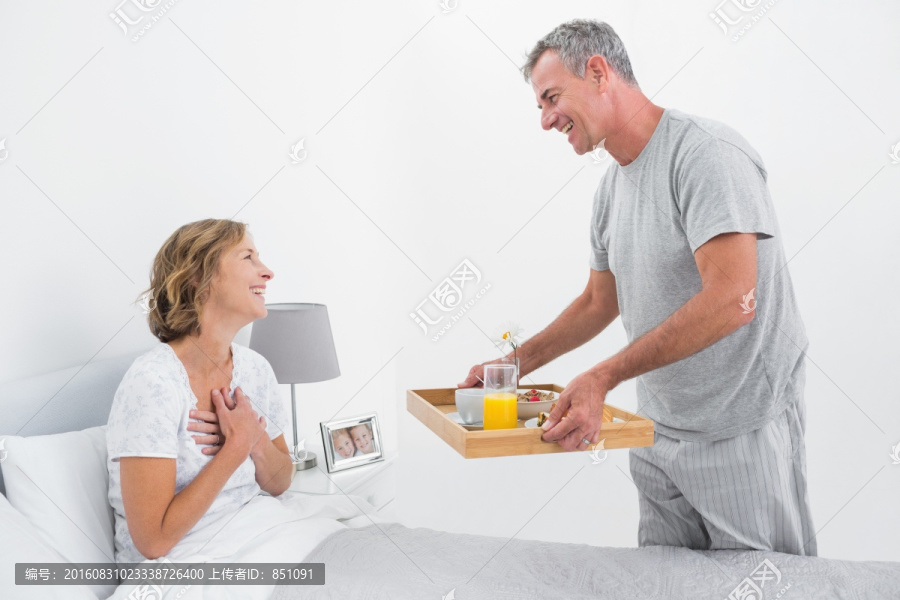 丈夫把早餐端给在床上的妻子