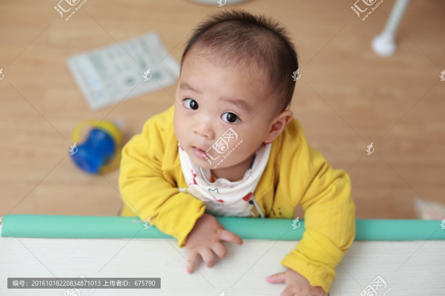 打扮时尚婴儿扶着桌子站着看镜头