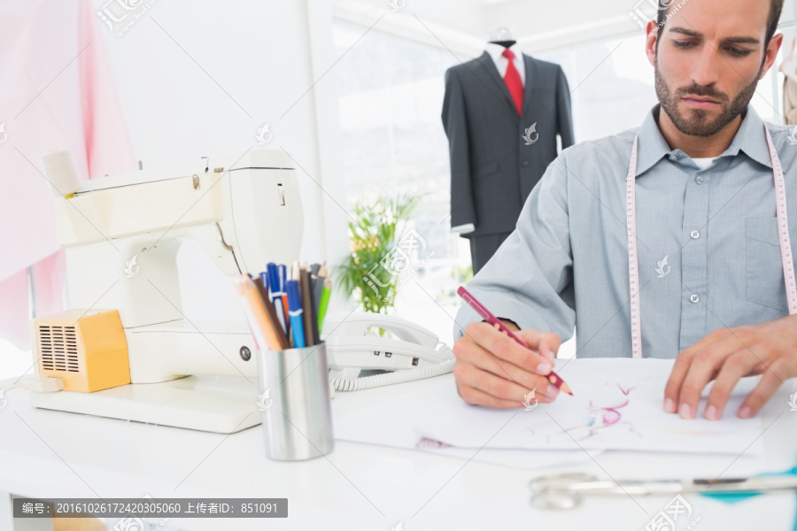 男时装设计师在工作室里画图纸