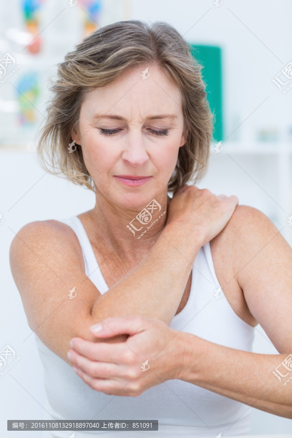 女人摸着疼痛的肩膀