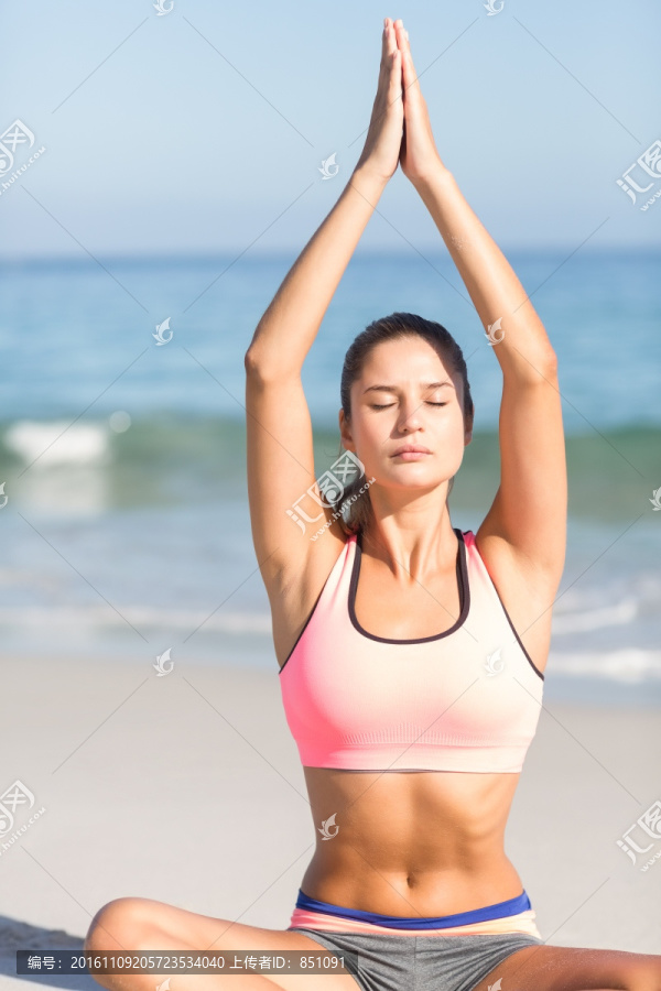 在沙滩上做瑜伽的女人