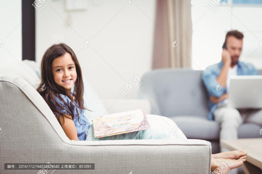 坐在沙发上画画的女孩