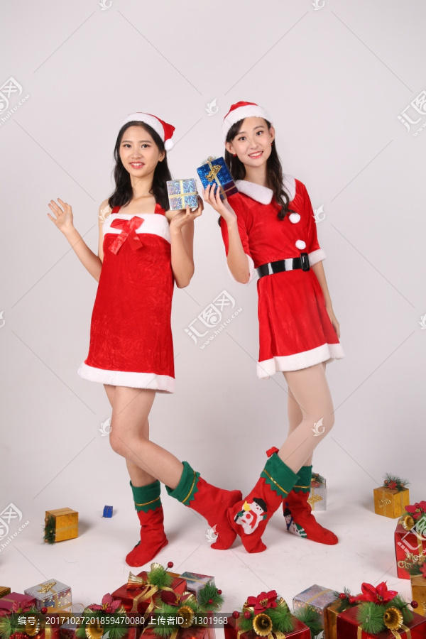 两女人拿着圣诞礼物微笑着