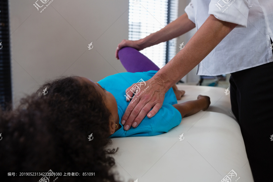 理疗师给女病人做腿部按摩