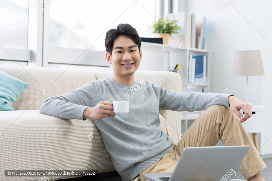 年轻男子在家使用笔记本电脑