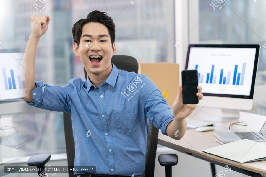 年轻商务男士在办公室使用手机