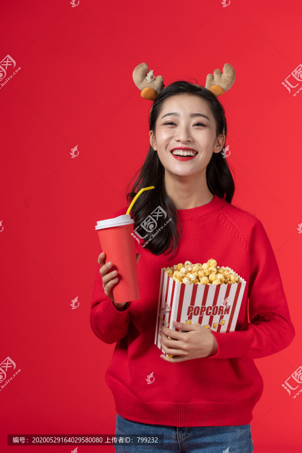 拿着爆米花和饮料的快乐女子