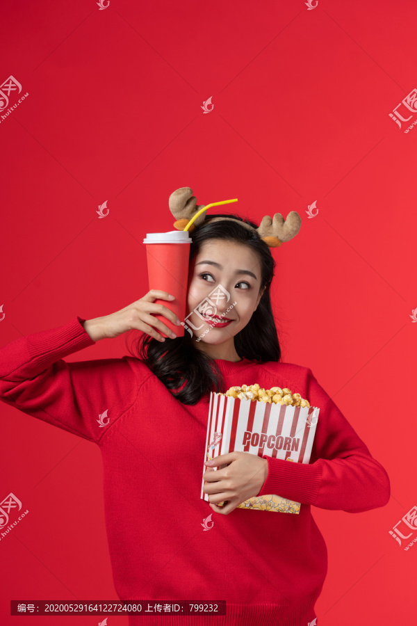 拿着爆米花和饮料的快乐女子