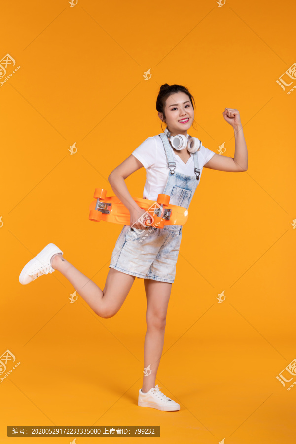 棚拍拿着滑板的年轻女子