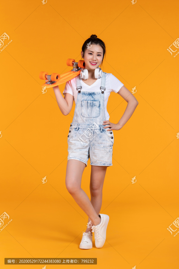 棚拍拿着滑板的年轻女子