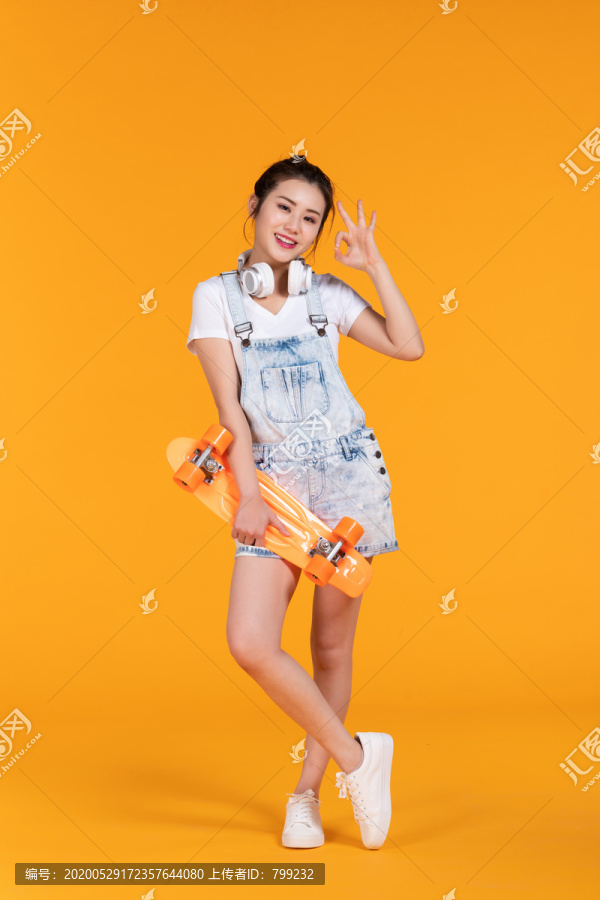 棚拍拿着滑板的年轻女子