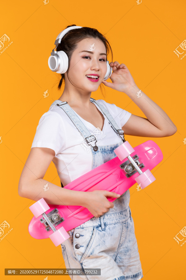棚拍拿着滑板的年轻女子
