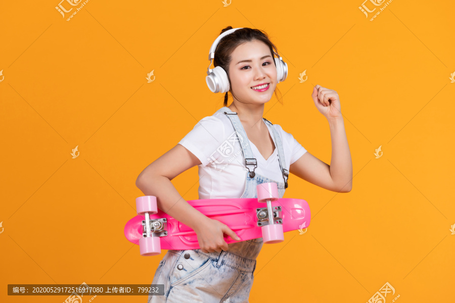 棚拍拿着滑板的年轻女子