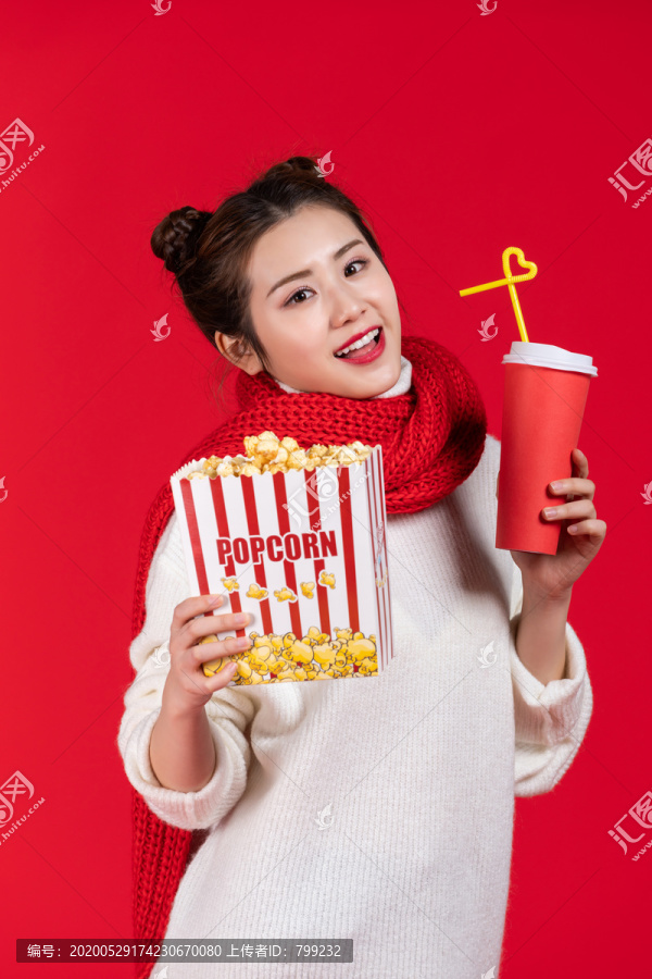 拿着爆米花和饮料的快乐女子