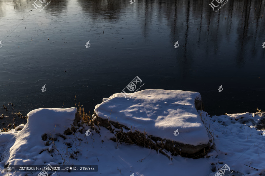 逆光下的湖岸雪景