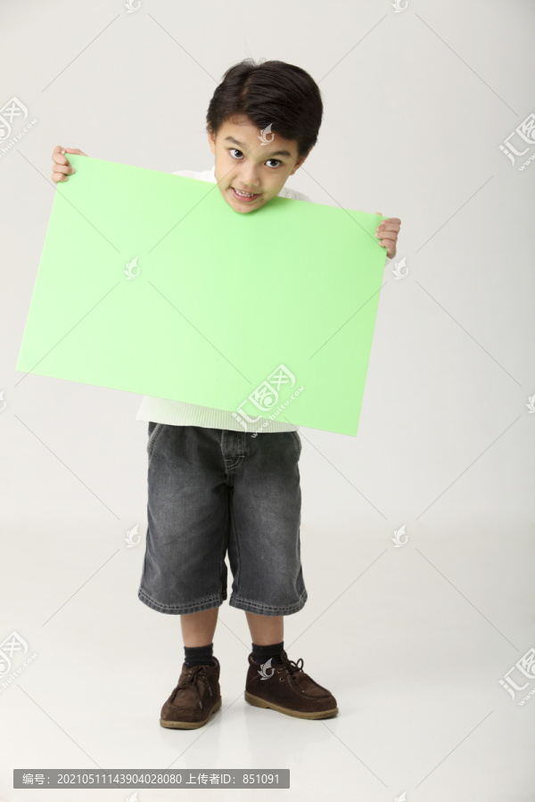 拿着绿纸板的男孩