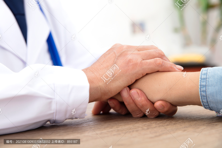 医生抚摸着患者的手表示安慰