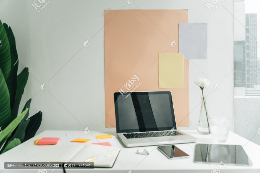 最小的办公桌，配备空白笔记本电脑和数码设备。复制空间和模型设计。