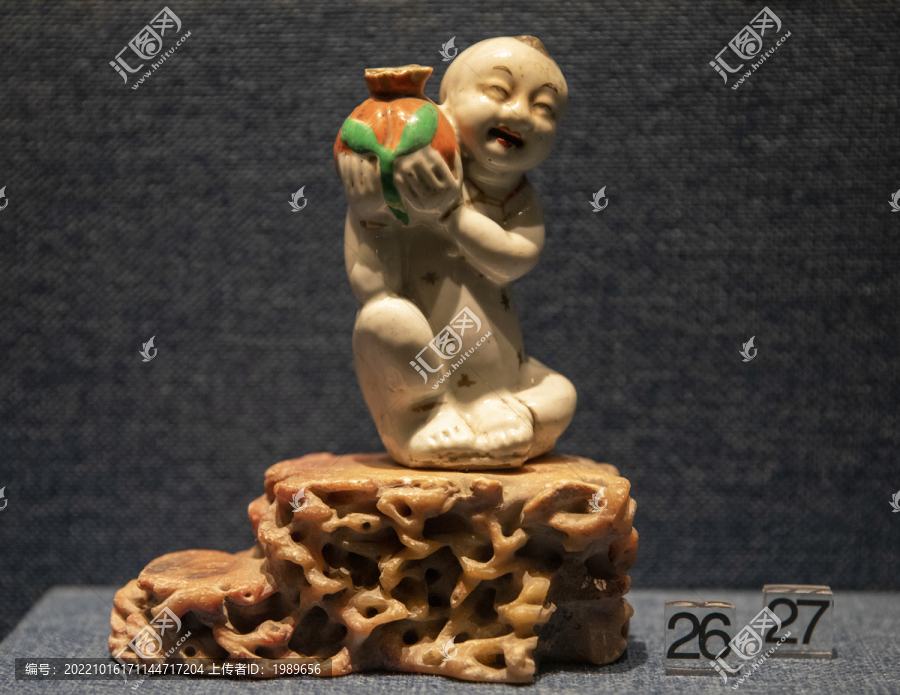 清代儿童肩扛红石榴瓷雕塑